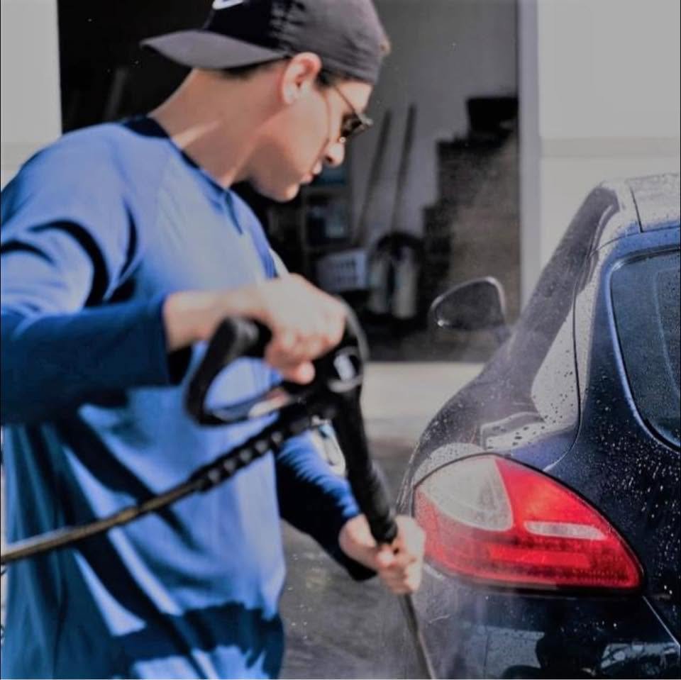 Matt pressure washing a vehicle
